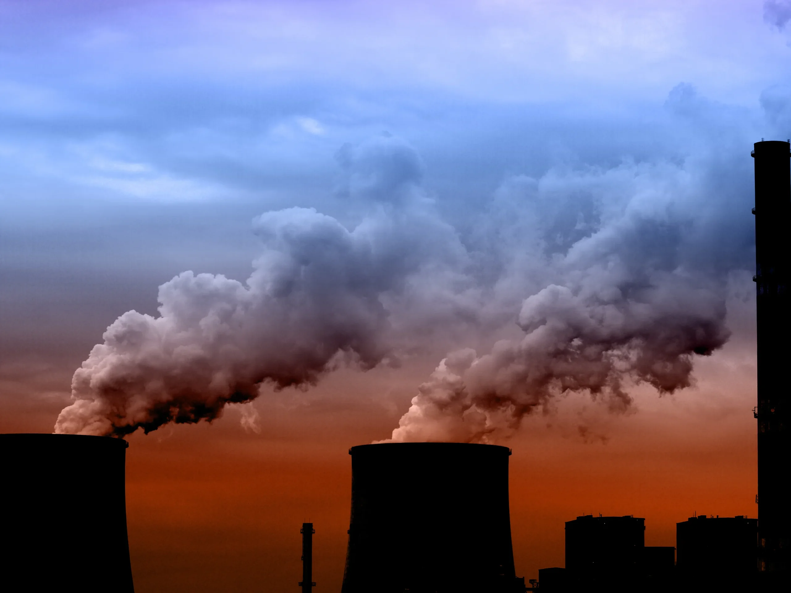 Clouds of emissions coming out of cooling towers.