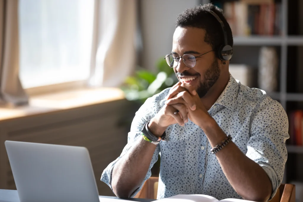 A smiling participant attends an online business writing course.