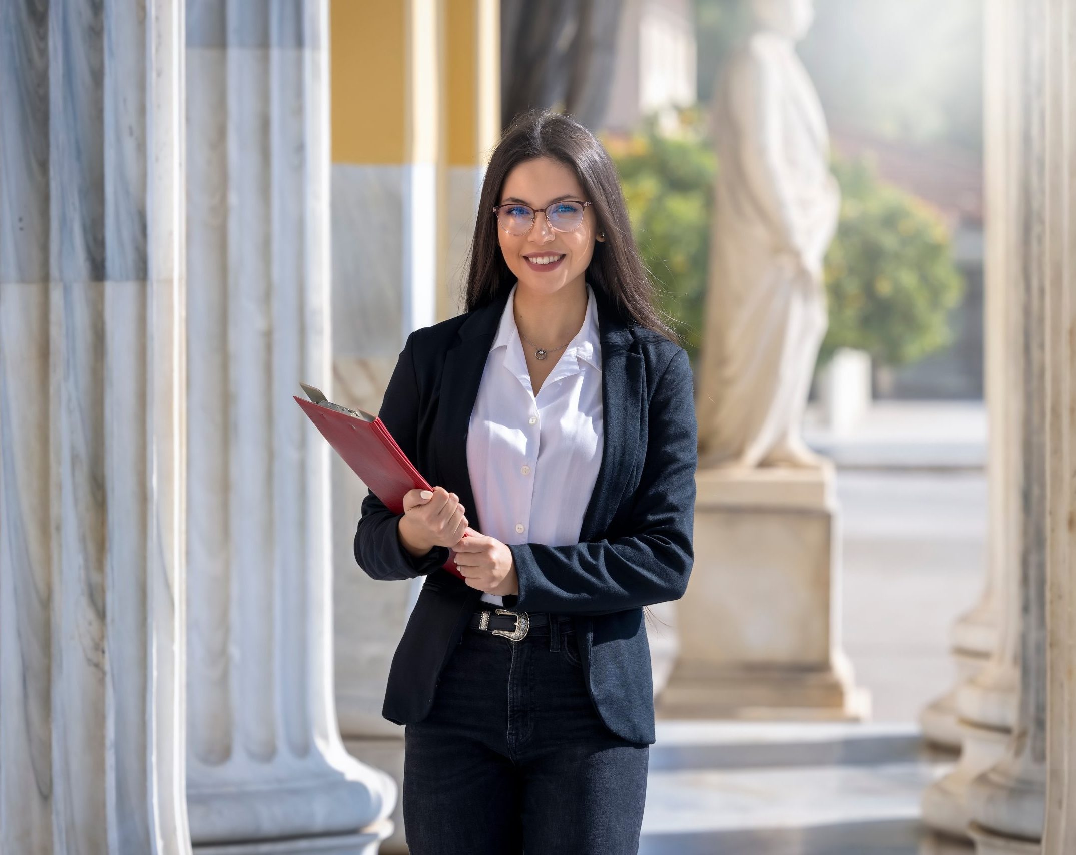 A woman holding documents outside law courts