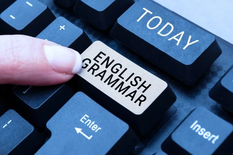 To sign up for grammar courses, person pushes button on keyboard reading, ‘English grammar’.